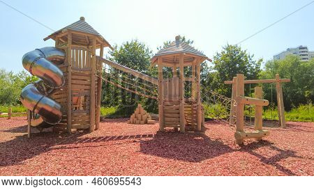 Modern Childrens Playground For Outdoor Games, A Slide Pipe Made Of Metal, Pyramids Made Of Wood