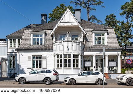 Latvia, Jurmala, July, 2022: Exterior View Renovation Wooden Home Among Tall Pine Trees On The Quiet