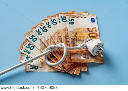 Knotted Power Cable With Electric Plug On Fan Shaped 50 Euro Banknotes Over Blue Background. Soaring