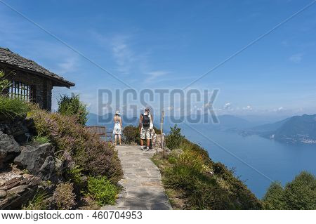 Tourists In The Giardino Botanico Alpinia Park Overlooking Lake Maggiore Near Stresa. Stresa Is A To