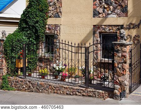 Brest, Belarus - August 18, 2022: Beautiful Stone House Decorated With Flowers And Greenery In Kamen