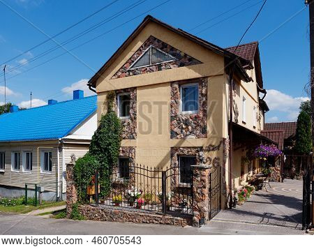 Brest, Belarus - August 18, 2022: Beautiful Stone House Decorated With Flowers And Greenery In Kamen