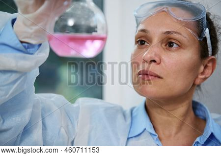 Multi-ethnic Middle-aged Woman Scientist Chemist In White Lab Coat And Goggles, Works With Liquids I