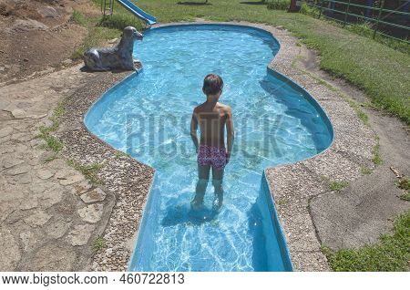 Child Boy At Guitar-shaped Swimming Pool Beside Vadillo Natural Pool. Losar De La Vera, Caceres, Ext