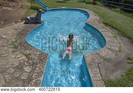 Child Boy At Guitar-shaped Swimming Pool Beside Vadillo Natural Pool. Losar De La Vera, Caceres, Ext