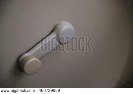Beige Interior Of The Car. Door Handle From The Inside Close-up. An Old-style Pen. Mechanical Openin