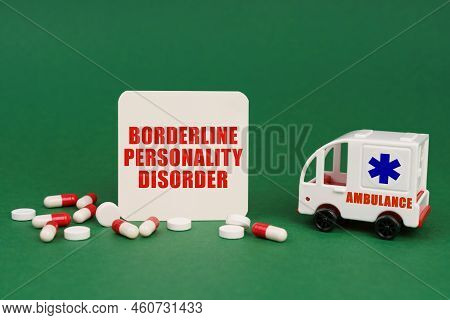 Medical Concept. On A Green Surface, An Ambulance, Pills And A Sign With The Inscription - Borderlin