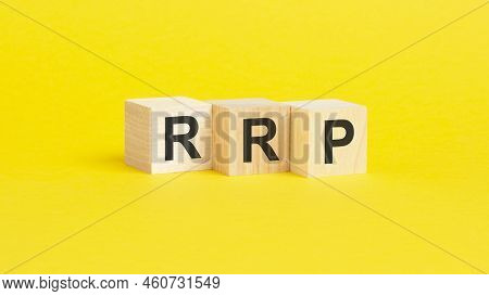 Wooden Blocks With Text Rrp - Recommended Retail Price - On Yellow Paper, Business Concept