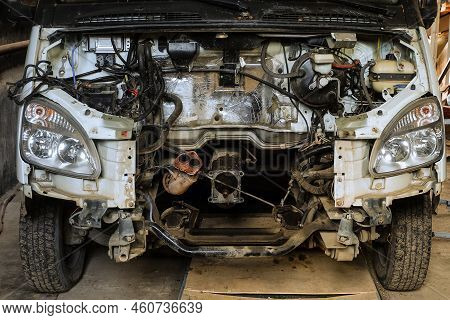 Engine Compartment Of A Van Car Without An Motor. Open Hood With Old Cars Details, Auto-waste.
