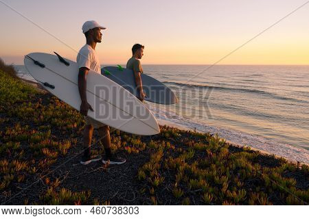 Surfers Watching The Waves At Sunset On Top Of A Sand Dune In Maceda, Ovar -  Portugal.