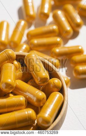 Turmeric Plus Black Pepper Extract Gelatin Capsule Close Up In Soft Focus. Herbal Supplement Organic