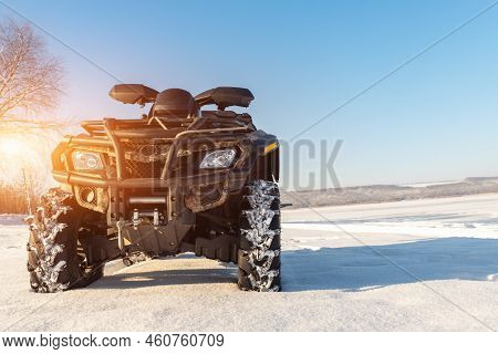 Front Pov Close-up Detail View Of Quad Bike Offroad Vehicle Parked In Snowdrift Track On Sunny Snowy