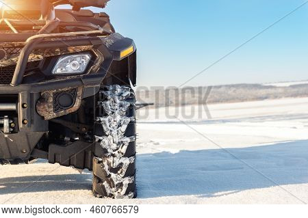 Front Pov Close-up Detail View Of Quad Bike Offroad Vehicle Parked In Snowdrift Track On Sunny Snowy