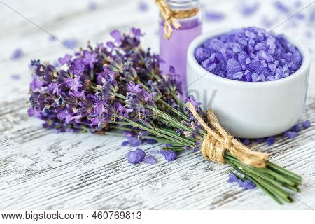 Lavender's Spa Products With Dried Lavender Flowers On A Wooden Table. Flat Lay Bath Salt And Massag