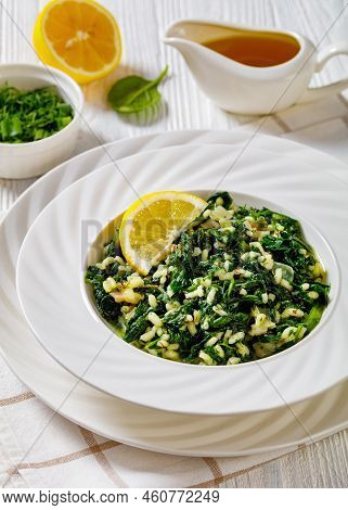 Spanakorizo, Greek Spinach And Rice Pilaf With Lemon, Dill, Spring Onion In White Bowl On White Wood