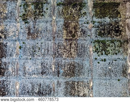 Dirty Old Eroded Cracked Plaster Cement Block Fence. Concrete Block Wall. Destroyed Crumbling Cement