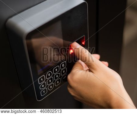 A Woman Opens The Door With Her Fingerprint. Modern Keyless Entry Lock.