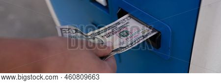 Woman Inserting Dollar Bills Into Atm On Street Closeup. Payment Concept