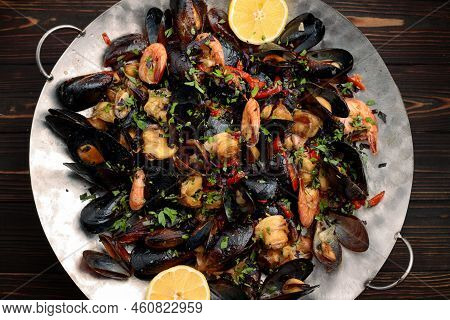 Grilled Seafood On A Metal Plate, On A Wooden Background. Saj