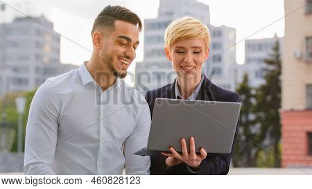 Serious Diverse Multiracial Couple Colleagues Arabic Hispanic Man And Caucasian Woman Standing Near 