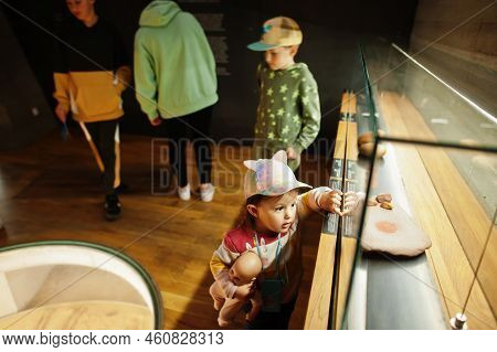 Mother With Children Exploring Expositions In Museum Halls.