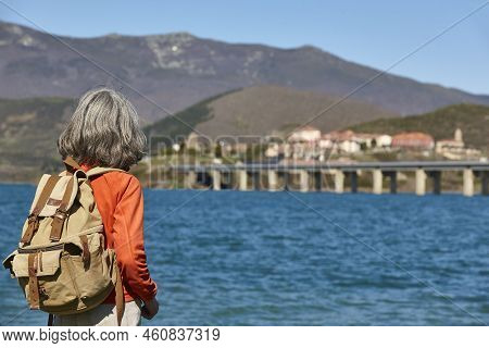 Woman Backpacker. Lake And Mountain Landscape. Castilla Leon, Spain