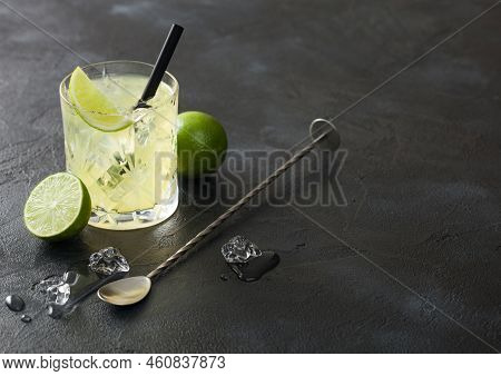 Gimlet Kamikaze Cocktail In Crystal Glass With Lime Slice And Ice On Black Background With Fresh Lim