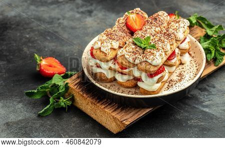 Tiramisu. Homemade Tiramisu Cake With Fresh Strawberry, Mascarpone And Mint. Tiramisu Portion On Pla