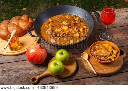 Festive Table For Rosh Hashanah Cholent, Pomegranate, Wine, Honey, Apples, Challah.