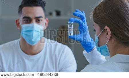 View From Behind Caucasian Unrecognizable Woman Doctor Wears Medical Gloves Holds Jar With Covid-19 