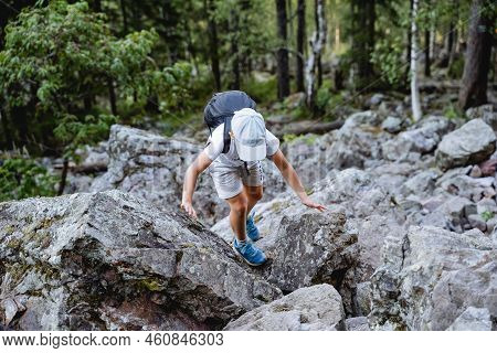 A Boy In A Hike Deftly Jumps On Stones, A Kurum Climb A Mountain, A Family Trip To The Forest, A Wal