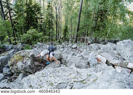 Family Trip Through The Mountains, The Boy Climbs Up The Big Stones, The Trail Passes Through The Ku