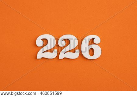 White Wooden Number 226 On Eva Rubber Orange Background