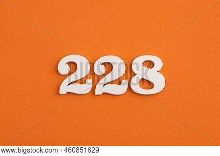 White Wooden Number 228 On Eva Rubber Orange Background