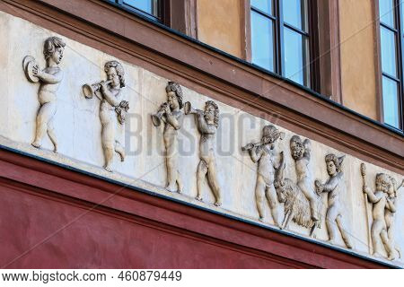 Relief Depicting Little Boys With Musical Instruments And Goat On Front Elevation Of Old Tenement Ho