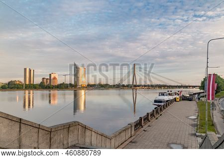 Riga, Latvia - June 20, 2022: Morning View On Embankment On Daugava River Seen From Stone Bridge (ak