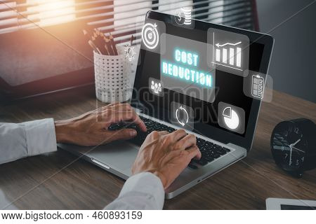 Cost Reduction Business Finance Concept, Businessman Hand Working On Laptop With Virtual Screen Cost