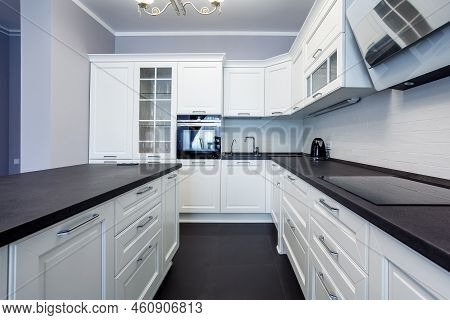 Fashionable Kitchen With Grey Walls And White Furniture, A Kitchen In A Modern Classic Style With Gr
