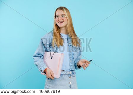 Smiling, Confident, Glad Blonde Teen Girl In Glasses Hold Paper Folder And Pen. Ready For School, Un