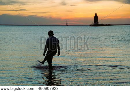 Silhouette Of A Man Enjoying The Sunset At Cape Henlopen State Park, Lewes, Delaware, U.s