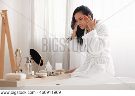 Attractive Woman Touching Face Looking At First Wrinkles In Bathroom