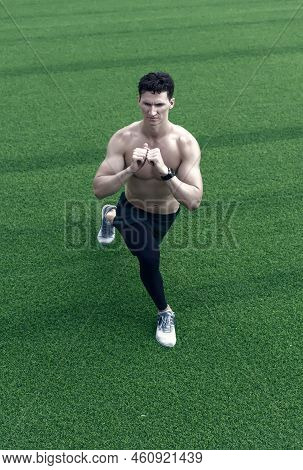 Fitness Man Working Out Outdoor. Man Training Body. Man With Muscular Body. Sporty Person Doing Stre