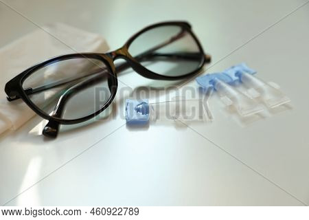Single Dose Eye Drops, Glasses And Fabric On White Table, Closeup
