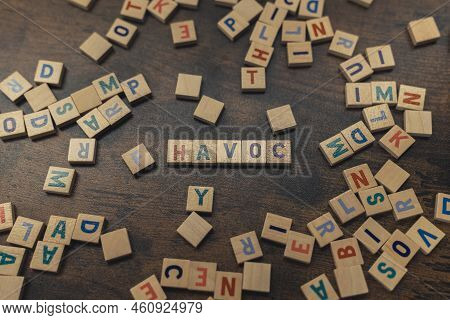 Word Play. Square Colorful Wooden Letters Creating The Word Havoc. Destruction And Demage Concept As