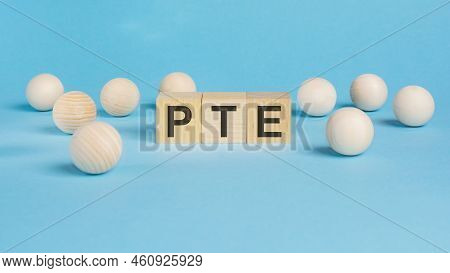 Business Concept. On The Blue Table Wooden Balls And Wooden Cubes With The Inscription - Pte - Pears
