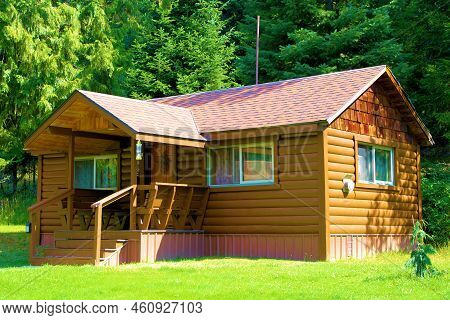 Rustic Wooden Cabin With A Front Porch On A Manicured Green Lawn Surrounded By An Alpine Evergreen F