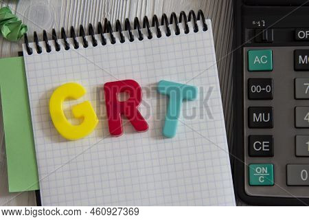 Grt (gross Receipt Tax) - Acronym In Multi-colored Letters Lies On The Notebook On The Background Of