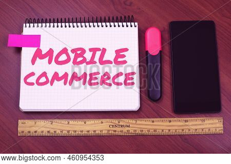 Text Caption Presenting Mobile Commerceusing Mobile Phone To Conduct Commercial Transactions Online.
