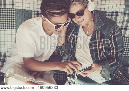 Couple Young And Old Grandmother And Teenager Nephew Family Time Together Listen Music With Earphone