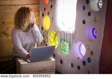 Alternative Home Or Office Workstation For Young Curly Beautiful Woman Sitting On The Floor Working 